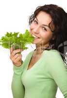 Beautiful young girl with green lettuce leaf
