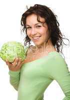 Beautiful young girl with green cabbage