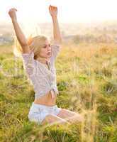 Girl is relaxing on green field