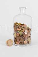 coins in glas bottle