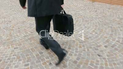 Close-up of legs and feet of businessman walking