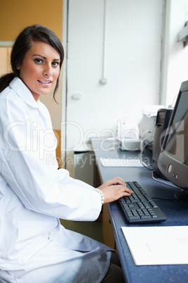 Portrait of a female scientist with a monitor