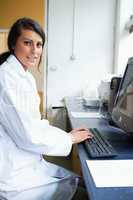 Portrait of a female scientist with a monitor