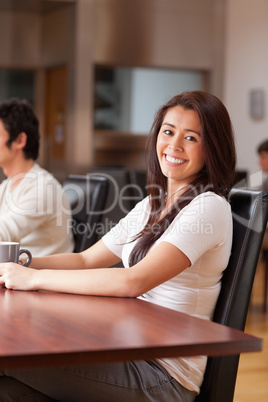 Portrait of a joyful woman having a cup of tea