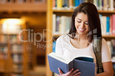 Cute student reading a book