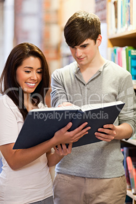 Portrait of happy students reading a book