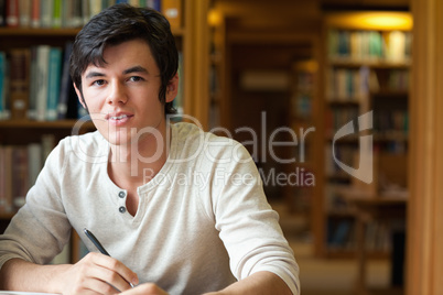 Student holding a pen