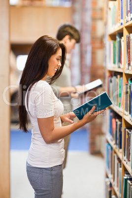 Portrait of students reading while standing up