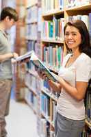 Portrait of a smiling student while holding a book