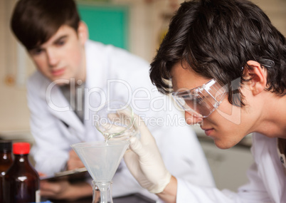 Close up of students in chemistry making an experiment