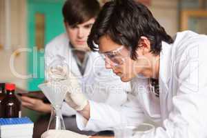 Students in chemistry making an experiment