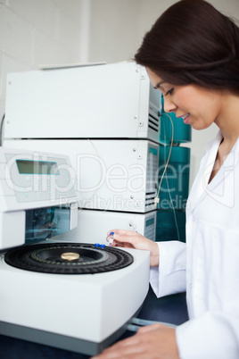 Laboratory assistant using a centrifuge