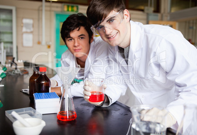Students showing a red liquid