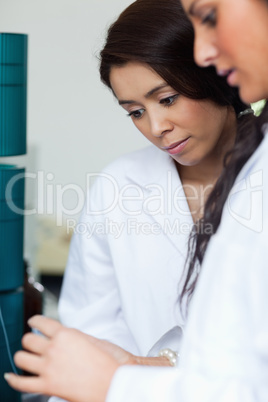 Portrait of students looking at a Petri dish