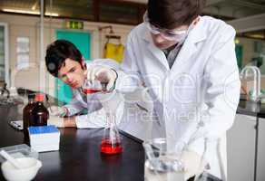 Young chemistry students making an experiment