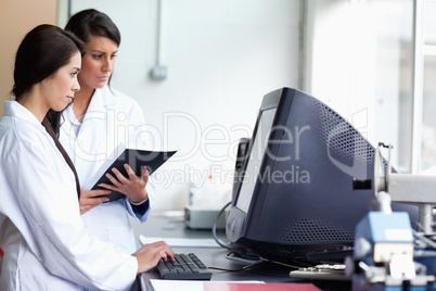 Female scientists using a monitor