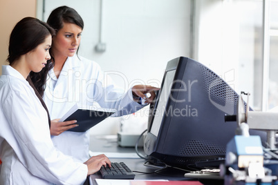 Female scientists looking at a monitor