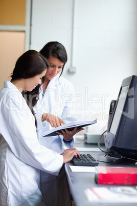 Portrait of female scientist comparing results