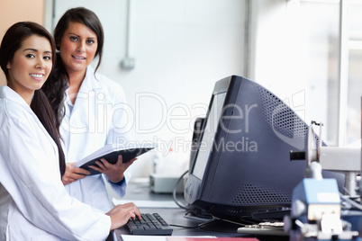 Smiling female scientist posing with a monitor