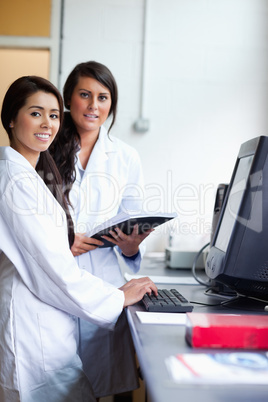 Portrait of female scientist posing with a monitor