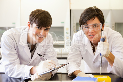 Handsome scientists making an experiment