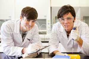 Handsome scientists making an experiment