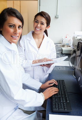 Portrait of scientists posing with a monitor