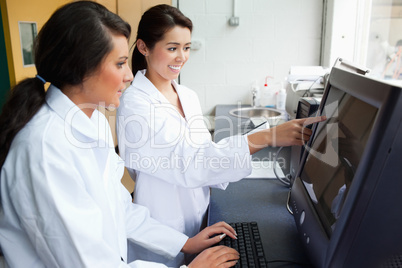 Cute scientists working with a monitor