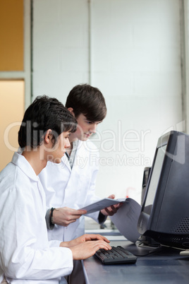 Portrait of male scientists using a monitor