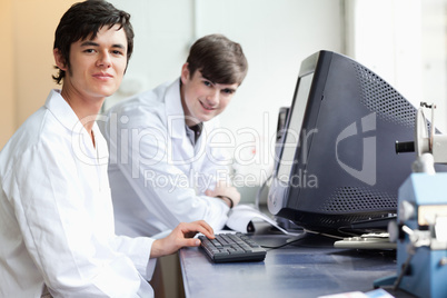 Students posing with a monitor