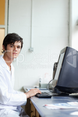 Portrait of a student posing with a monitor