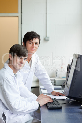 Portrait of scientists posing with a monitor