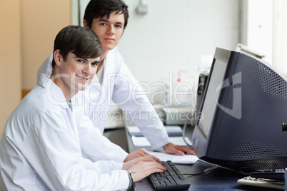 Scientists posing with a monitor