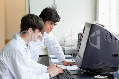 Scientists working with a monitor