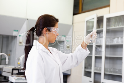 Female chemist looking at an Erlenmeyer flask