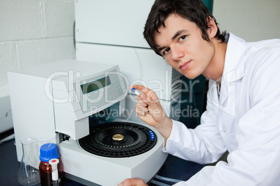 Student posing with a centrifuge