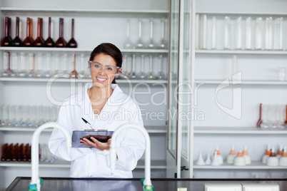 Smiling student in science writing on a clipboard
