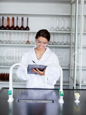 Portrait of a smiling student in science writing on a clipboard