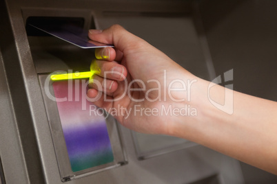 Close up of a hand inserting a credit card