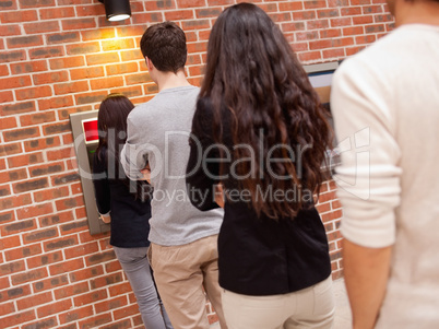 People queuing to withdraw cash