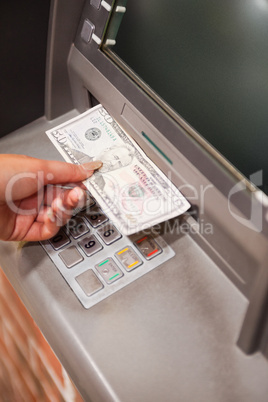 Portrait of a feminine hand withdrawing dollars