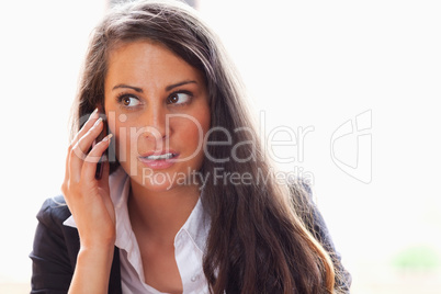 Surprised woman making a phone call