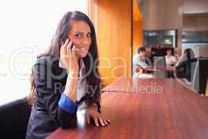 Smiling young woman making a phone call