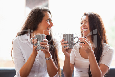 Laughing friends having a coffee