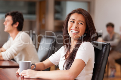 Laughing woman having a tea
