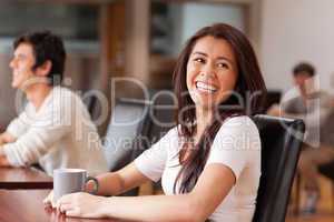 Laughing woman having a tea