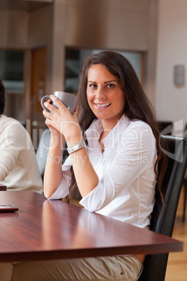 Portrait of a young woman having a coffee