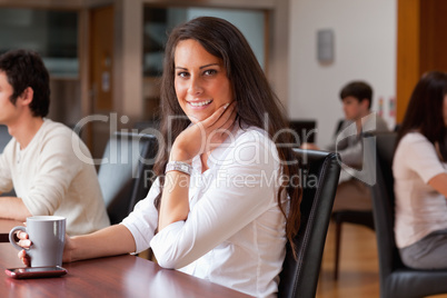 Smiling woman having a coffee