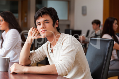 Young man sitting with a cup of tea