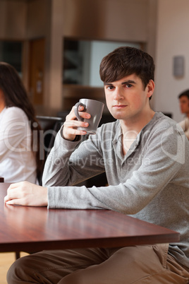 Portrait of a young man having a coffee